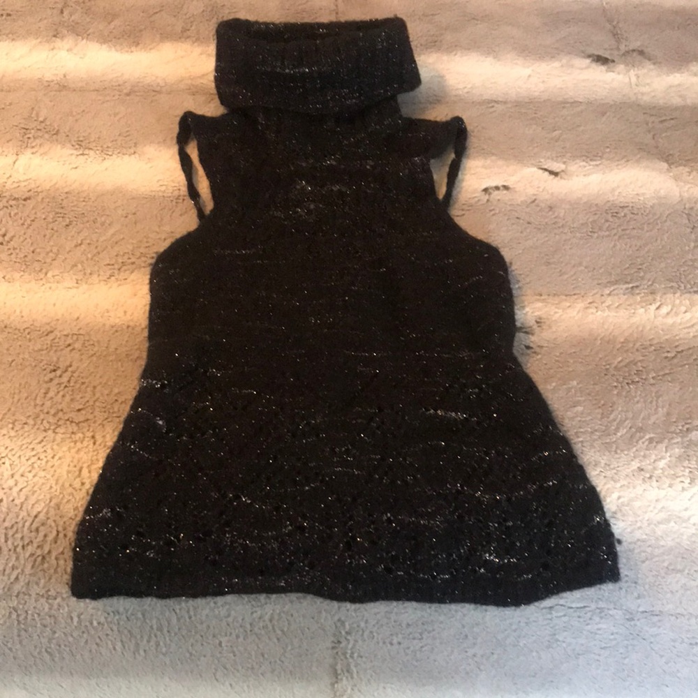 Black sleeveless turtleneck top with an open back